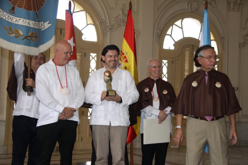 El secretario xeral da Emigración (en el centro de la imagen) hizo entrega del 'Premio da Galeguidade', otorgado por la  Enxebre Orde da Vieira, al presidente de la Federación de Sociedades Gallegas en Cuba,  Sergio Toledo