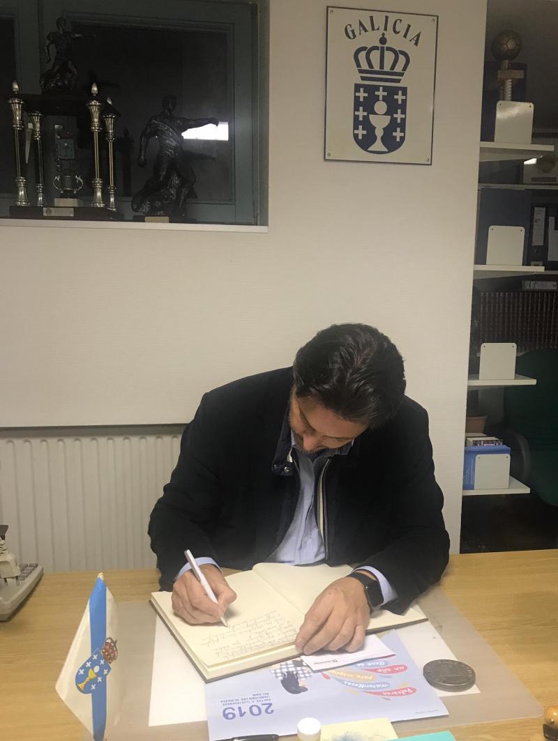 O secretario xeral da Emigración, asinando no Libro de honra do Centro Galego de Hannover